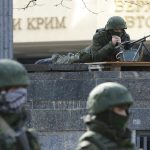 Armed men take up positions around the regional parliament building in the Crimean city of Simferopol