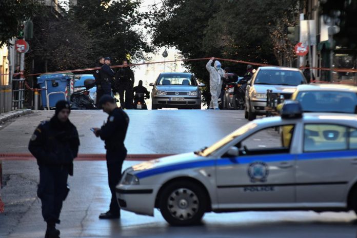 Police officers secure the area around the Saint Dionysios church, following the detonation of an explosive device in Athens