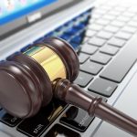 Online auction. Gavel on laptop. 3d