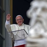 Pope Francis waves as he leads the Angelus prayer from the window of the Apostolic palace in Saint Peter’s Square at the Vatican