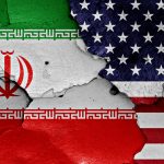 flags of Iran and USA painted on cracked wall