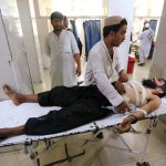 An injured man receives treatment at the hospital, after a suicide attack in Jalalabad, Afghanistan