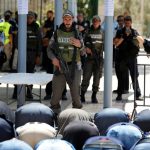 FILE PHOTO: Palestinians pray in front of Israeli policemen and newly installed metal detectors at an entrance to the compound known to Muslims as Noble Sanctuary and to Jews as Temple Mount in Jerusalem’s Old City