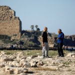 Israeli archaeologist Ehud Galili of the University of Haifa speaks to a colleague as they stand near the Mediterranean coast in Atlit, northern Israel