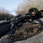 Pro-Russian separatist poses at a checkpoint near the village of Hrabove in Donetsk region