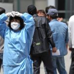 A medical worker wearing a protective mask and suit stands at a testing center for the coronavirus disease (COVID-19) in Seoul